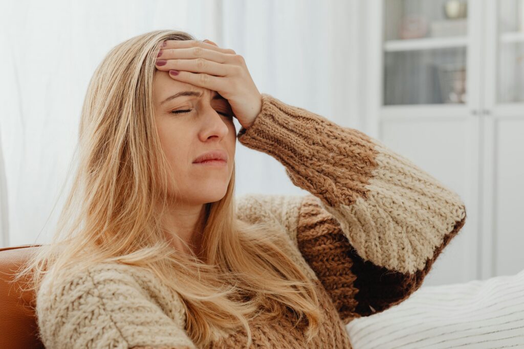 tired woman with her hand on her head